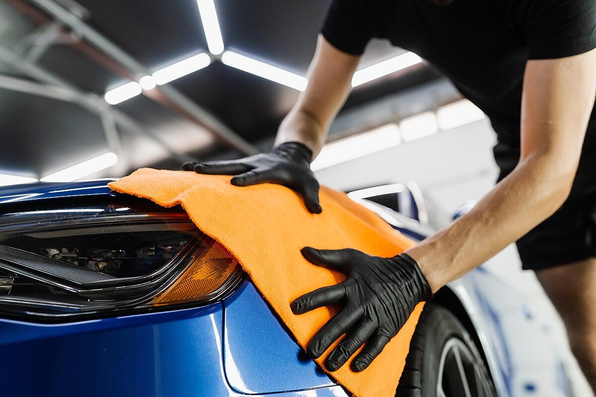 Hand car drying with microfiber in detailing auto service