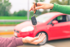 Car owner handing over the keys to a buyer.