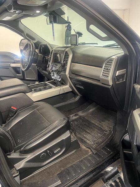 The front passenger's side of a Ford F350 that that is dirty. This is before it is detailed by Andy's Autowash.