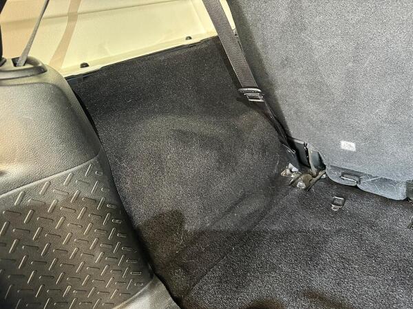 The inside of the left back side of a car after it is detailed. Showing there their is no longer any pet hair.