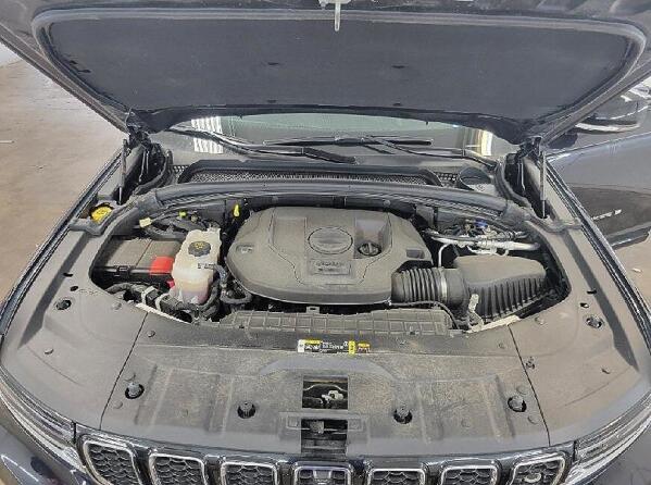 Under the hood of a vehicle. Showing how dirty it looks before the engine cleaning service by Andy's Autowash. 