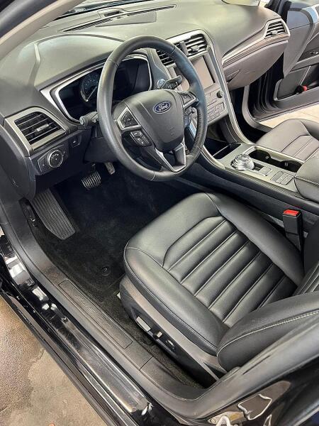 The front drivers side of a Ford car after it was cleaned by Andy's Autowash. Showing all the shine on the seat & console.