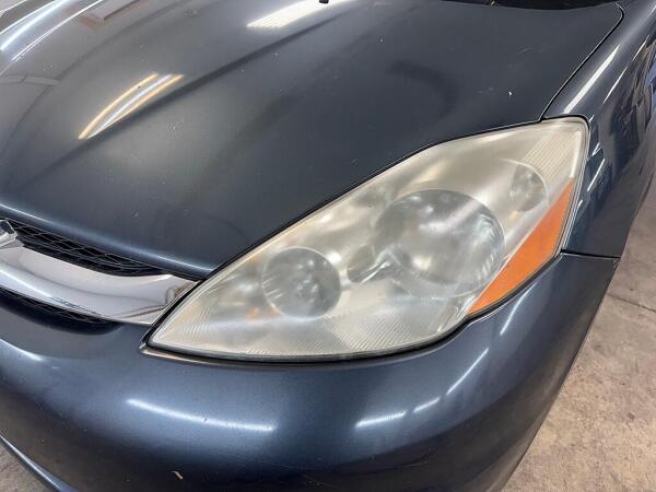 A cloudy passenger's side headlight before it had the Headlight Restoration service by Andy’s Autowash. 